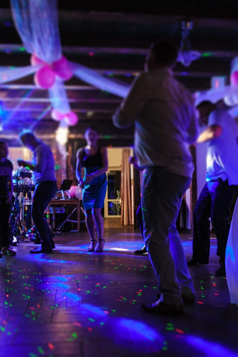 Bride and groom dancing the first dance at their wedding day. Guest on the dancefloor