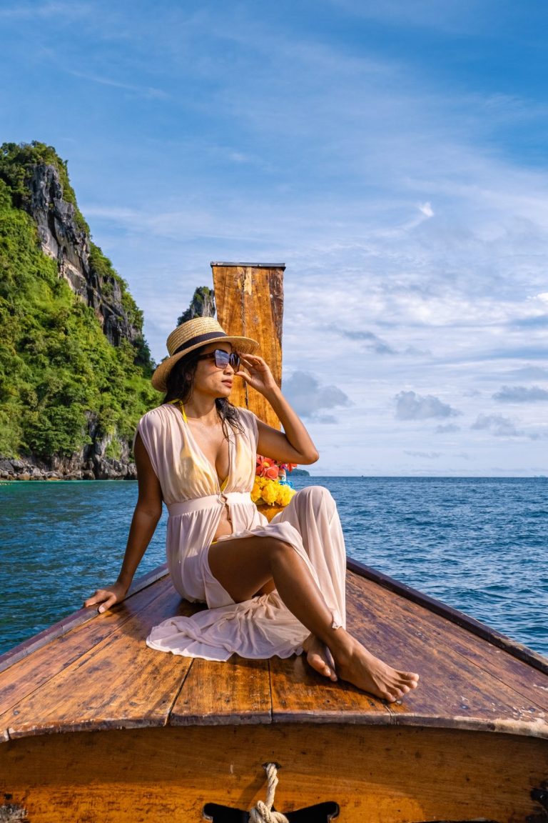 Koh Phi Phi Thailand, Asian woman in longtail boat exploring the Phi Phi Lagoon around the Island.